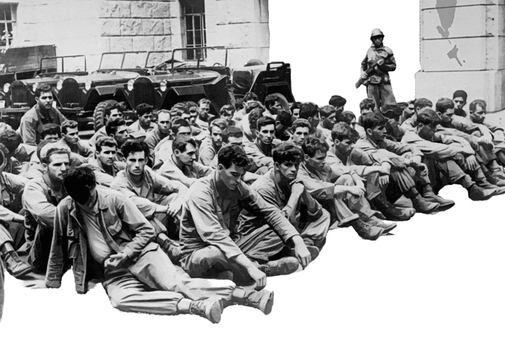 Captive soldiers seated on the ground under guard during wartime imprisonment.