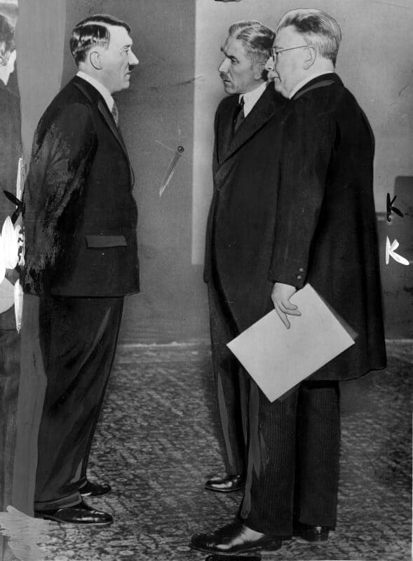 Adolf Hitler speaks with Franz von Papen and President Hindenburg in a formal meeting prior to his appointment as chancellor.