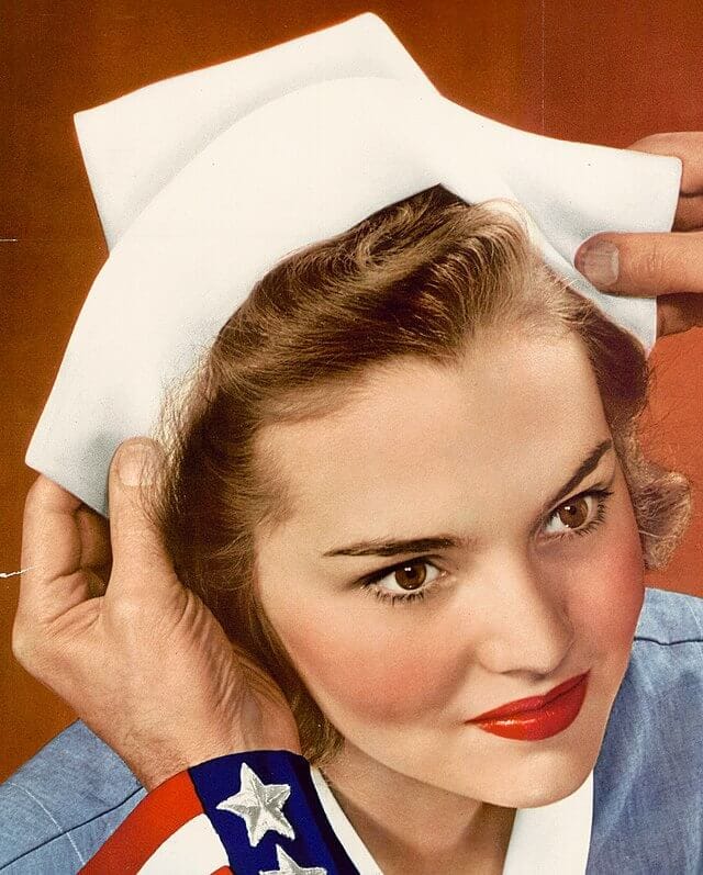 Wartime propaganda image of a young nurse being ceremonially capped by hands in a U.S. military uniform, symbolizing patriotic service.