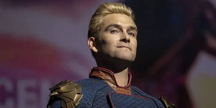 Homelander standing in spotlight with proud expression and crossed arms